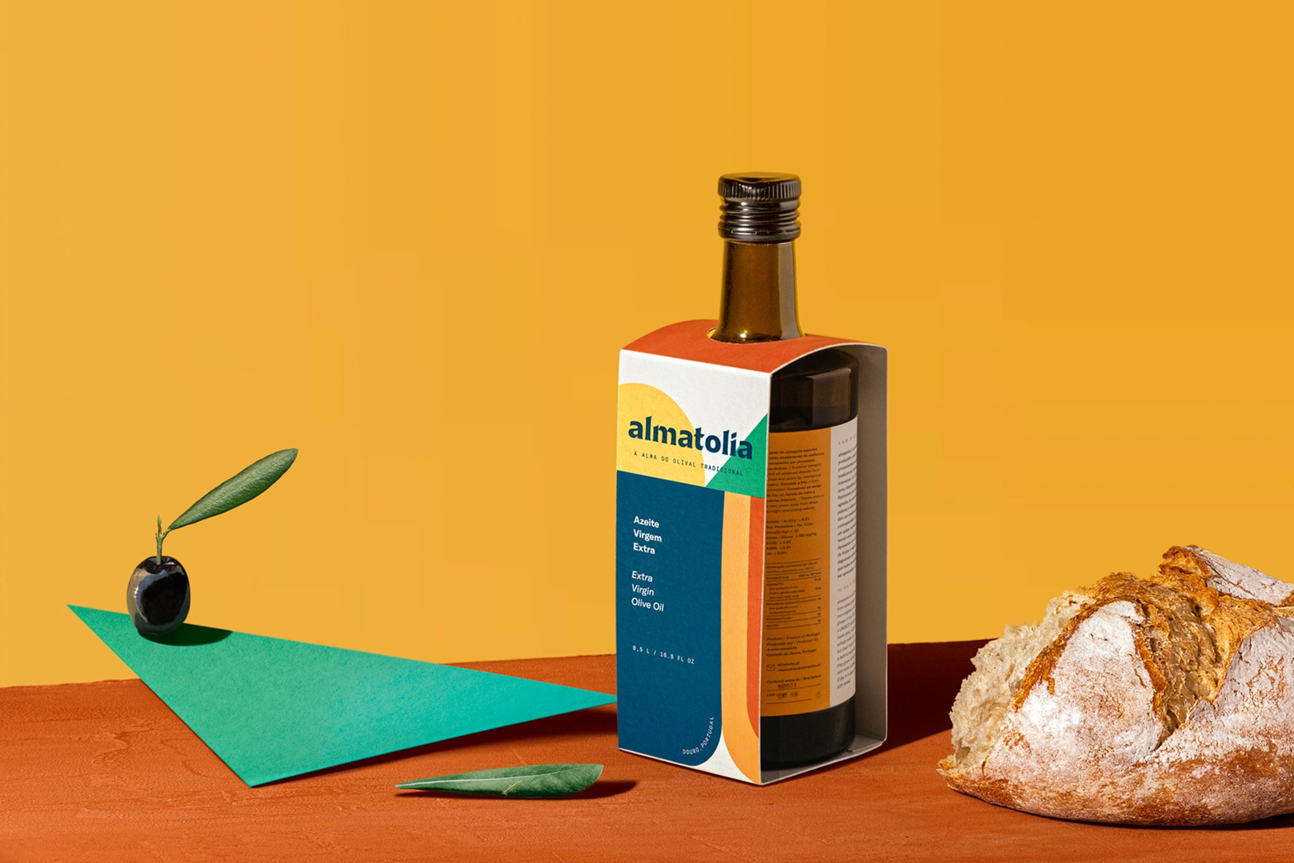 Almatolia bottle with bread and olive arrangement.