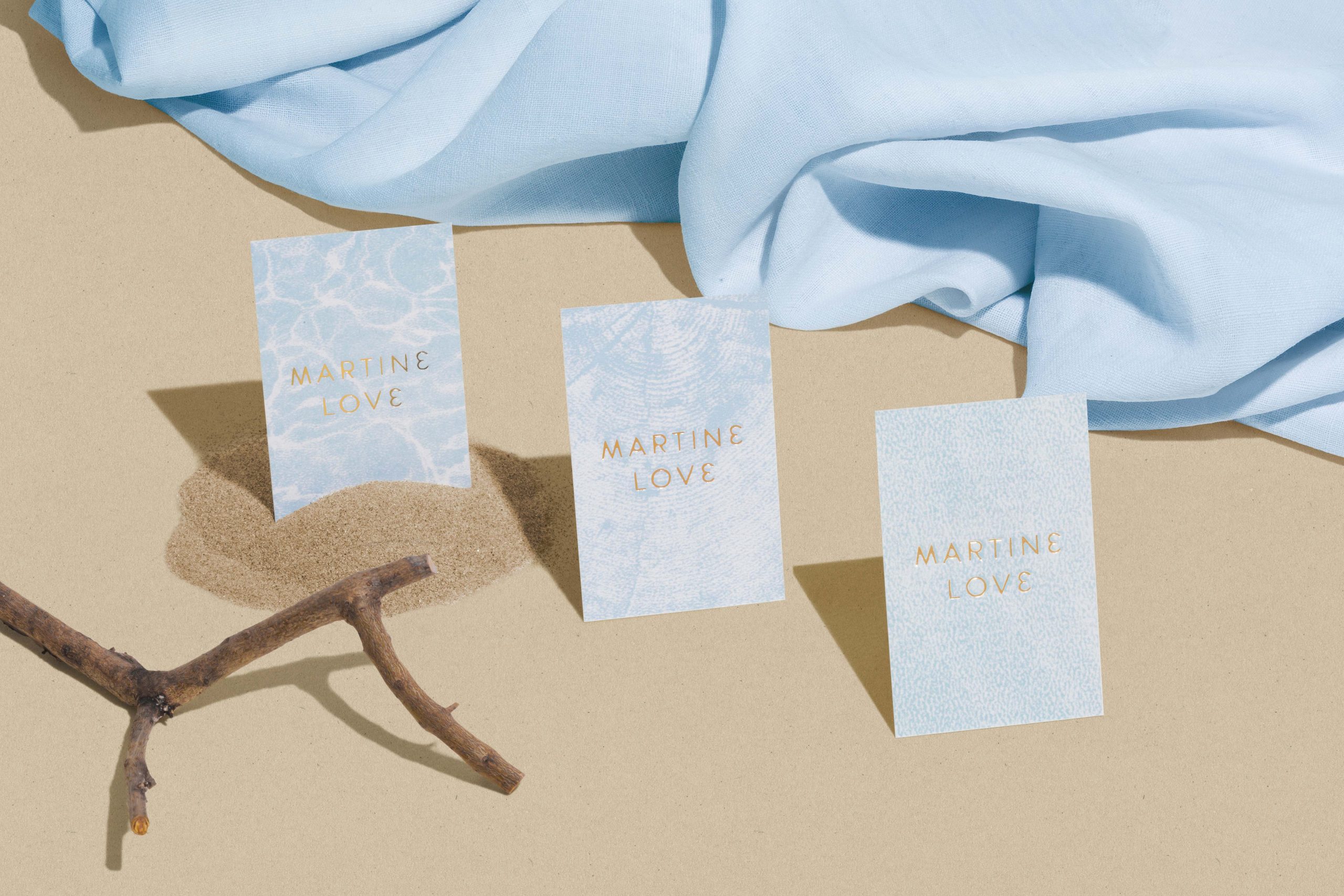 Martine Love business cards with sand and fabric.